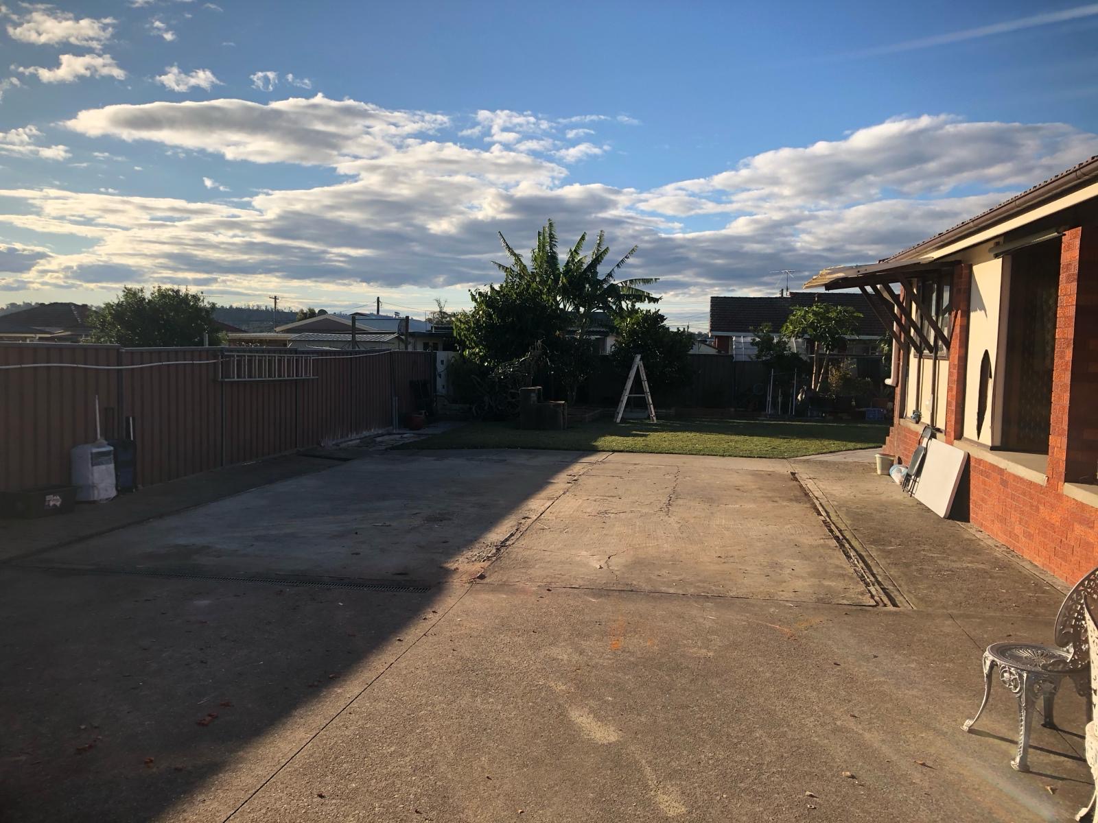 Backyard after garage and carport demolition — clean level concrete slab area