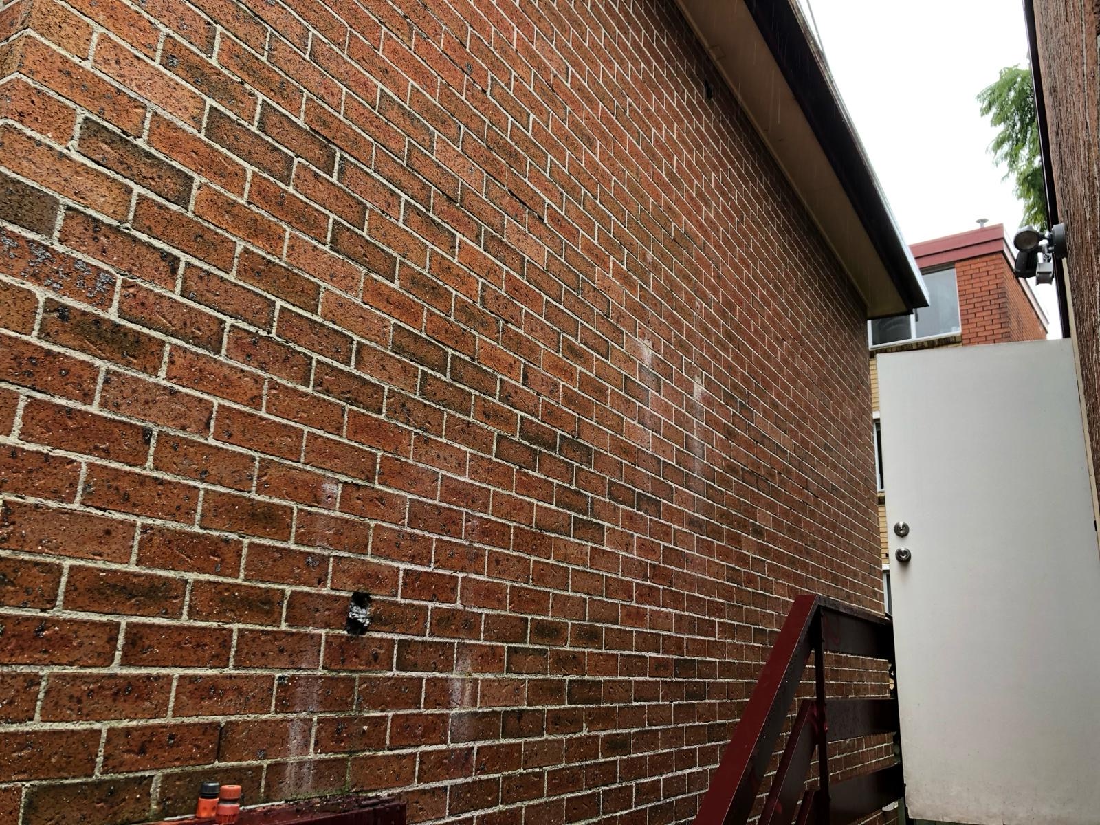 Double brick side wall of a home before attached structure removal