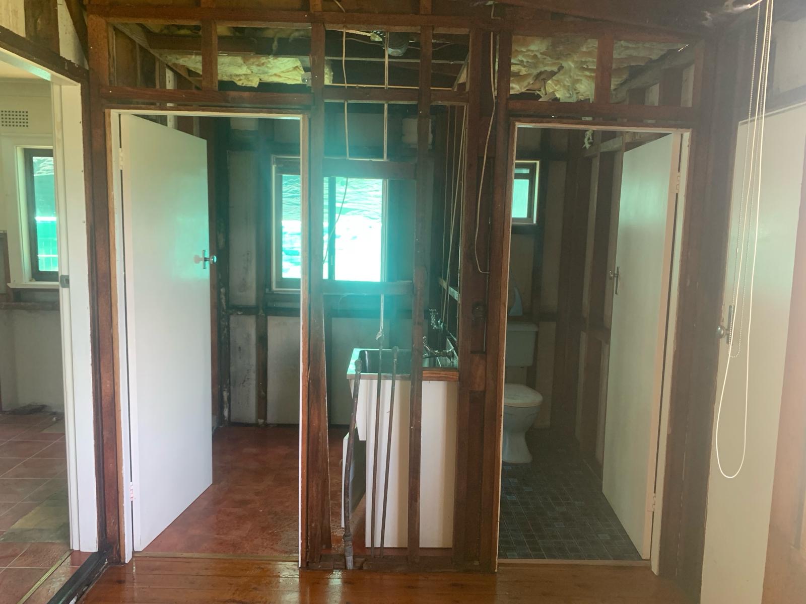 Same interior after stripout — walls and ceiling removed down to the timber frame