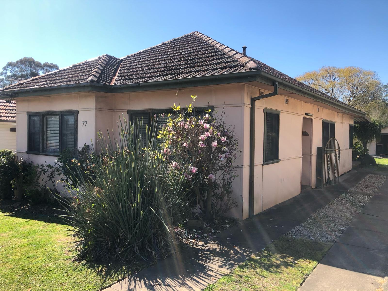 Fibro-clad cottage before demolition work began, front elevation with tiled roof